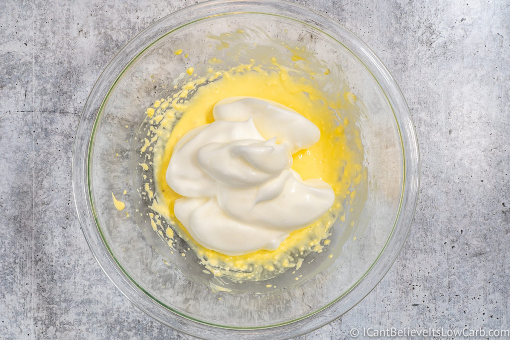 adding egg whites to eggs and cream cheese mixture
