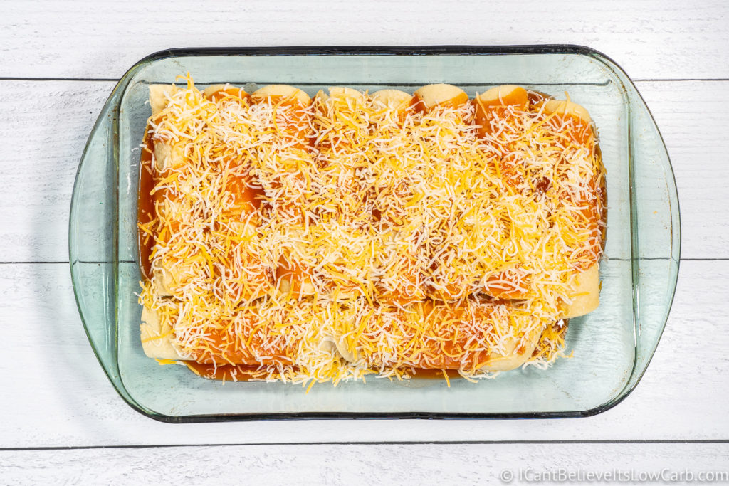 topping enchiladas with cheese