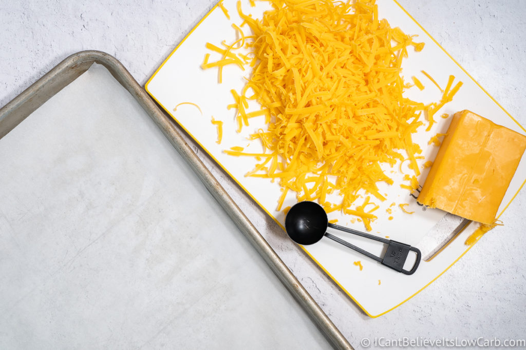 shredded cheddar cheese and a small measuring spoon