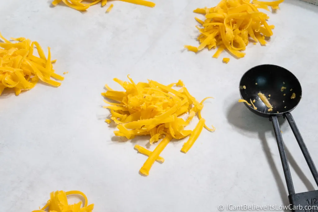 Small scoops of cheese on a sheet pan