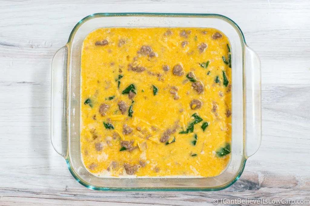 Filling baking dish with Breakfast Casserole mixture