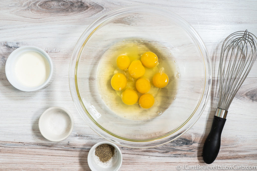 adding eggs to glass bowl