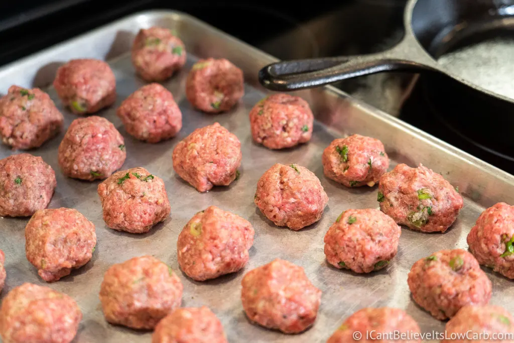 Raw meatballs on a baking tray