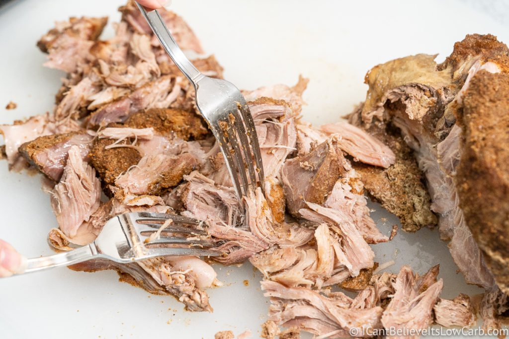 pulling apart the Pulled Pork with forks