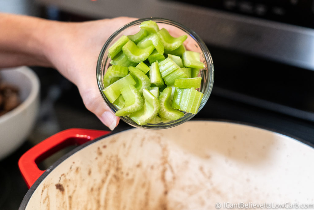 Adding celery to the pan