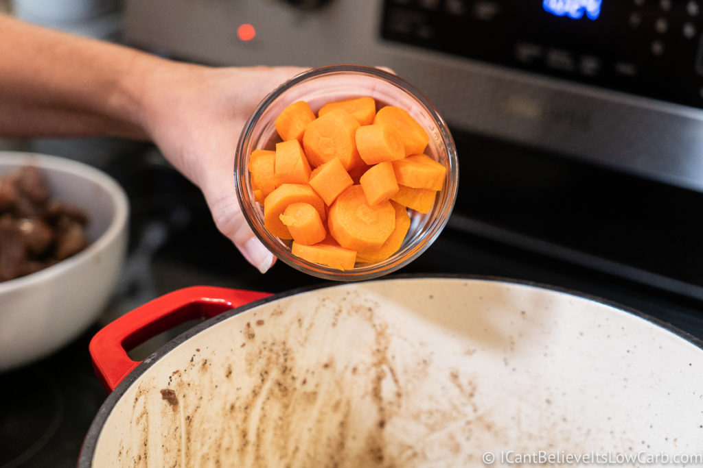 Adding carrots to the pan