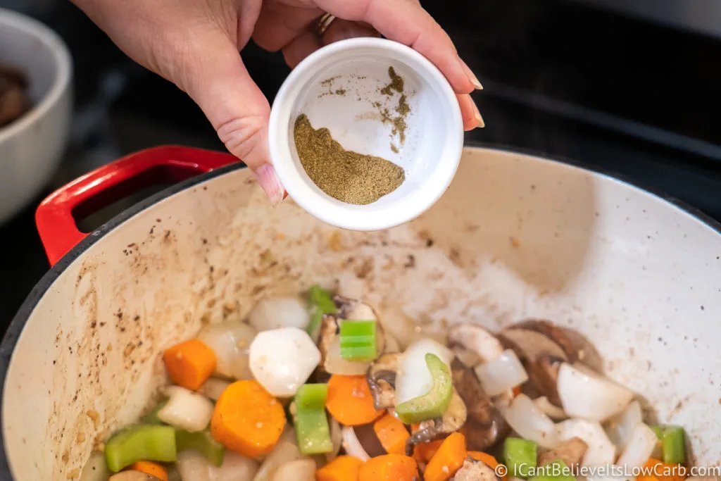 Adding black pepper to the pan