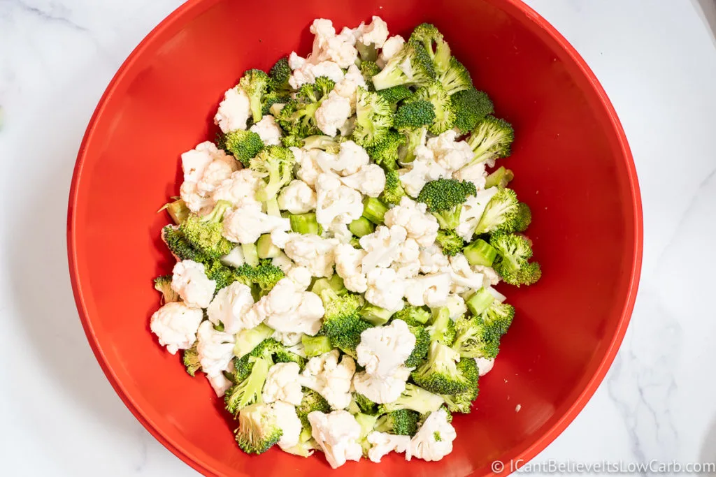 Mixing Broccoli and Cauliflower in a red bowl
