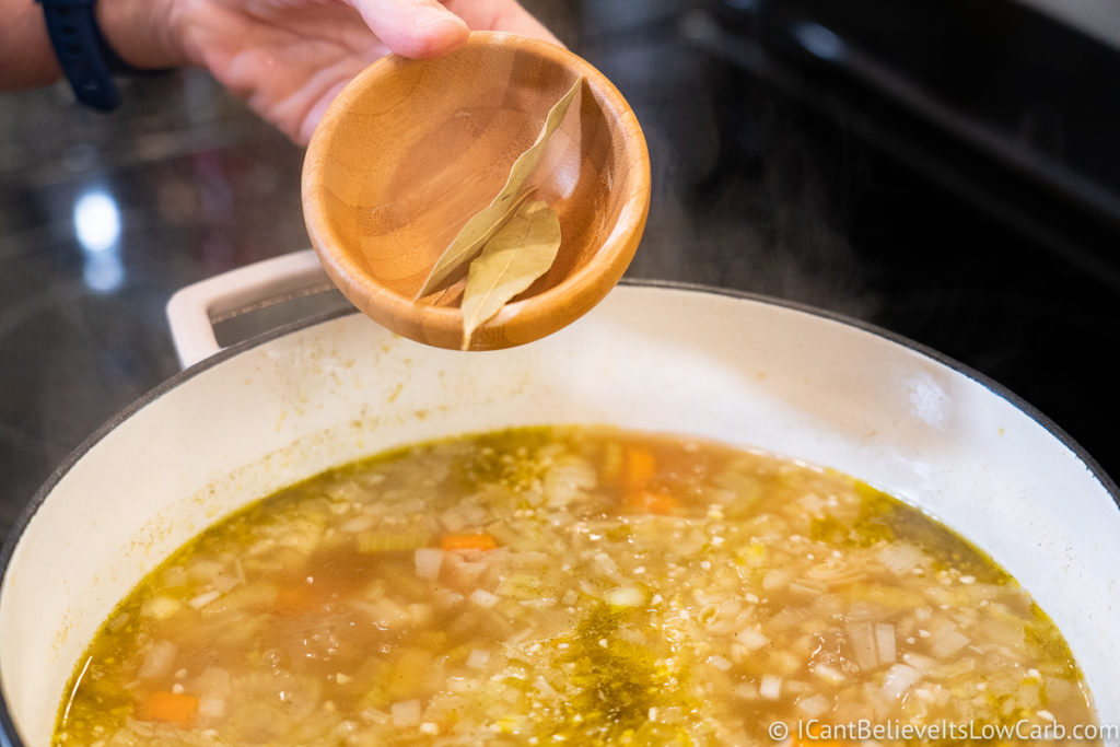 Adding bay leaves to the soup