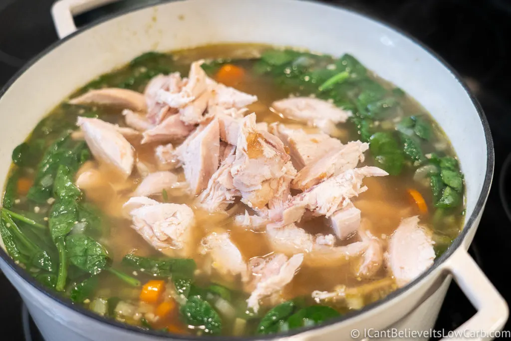 Adding chicken to the soup
