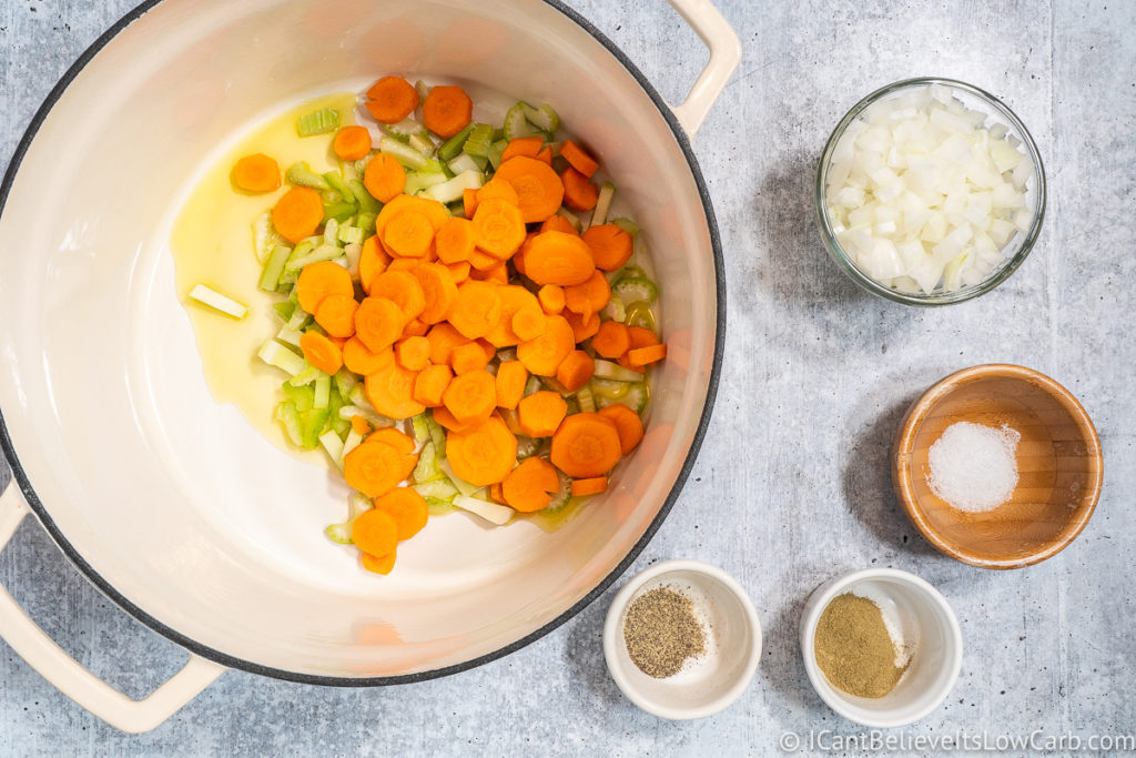 Adding carrots to the pan