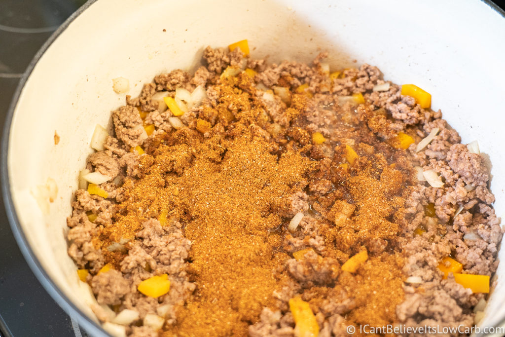 Adding taco seasonings to the pan