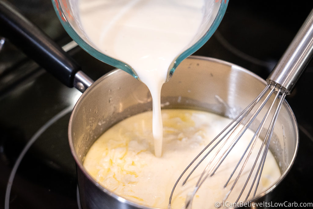 adding heavy cream to the pan