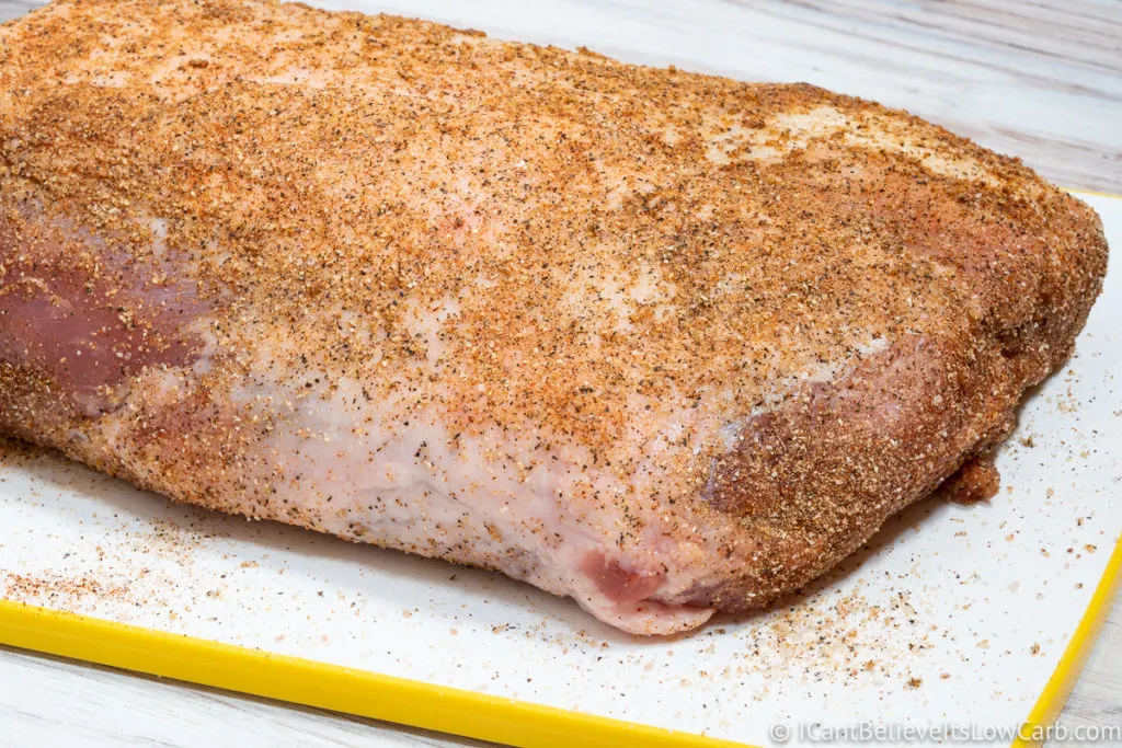 A seasoned Pork Loin on a cutting board