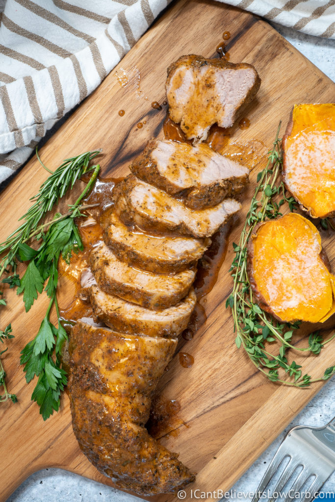 Instant Pot Pork Tenderloin on cutting board with sweet potato