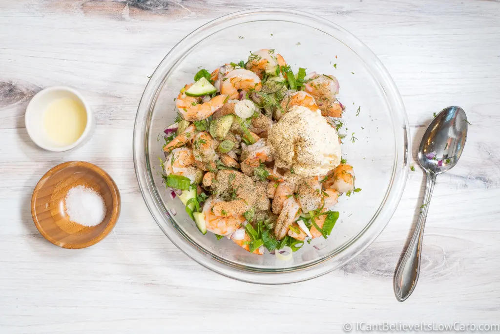 Adding the black pepper to Shrimp Salad