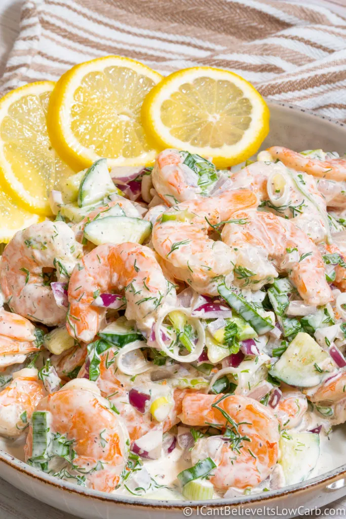 Shrimp Salad in a bowl with sliced lemons