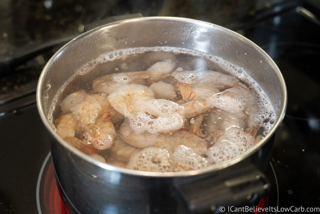 boiling shrimp in a pot of water