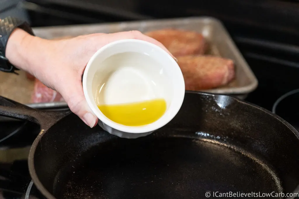 Adding olive oil to a frying pan