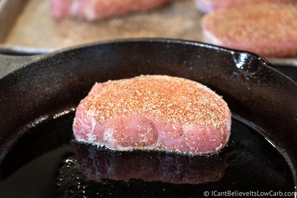 Searing Pork Chops in a cast iron pan before baking