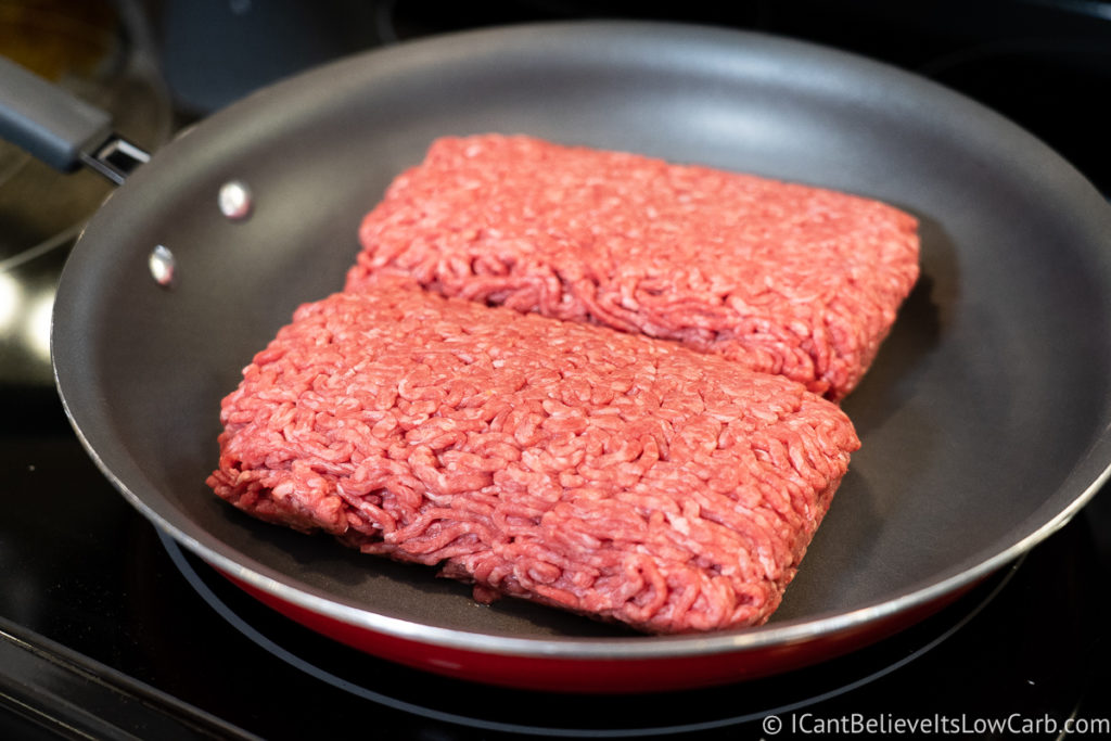 ground beef cooking in a pan on the stove