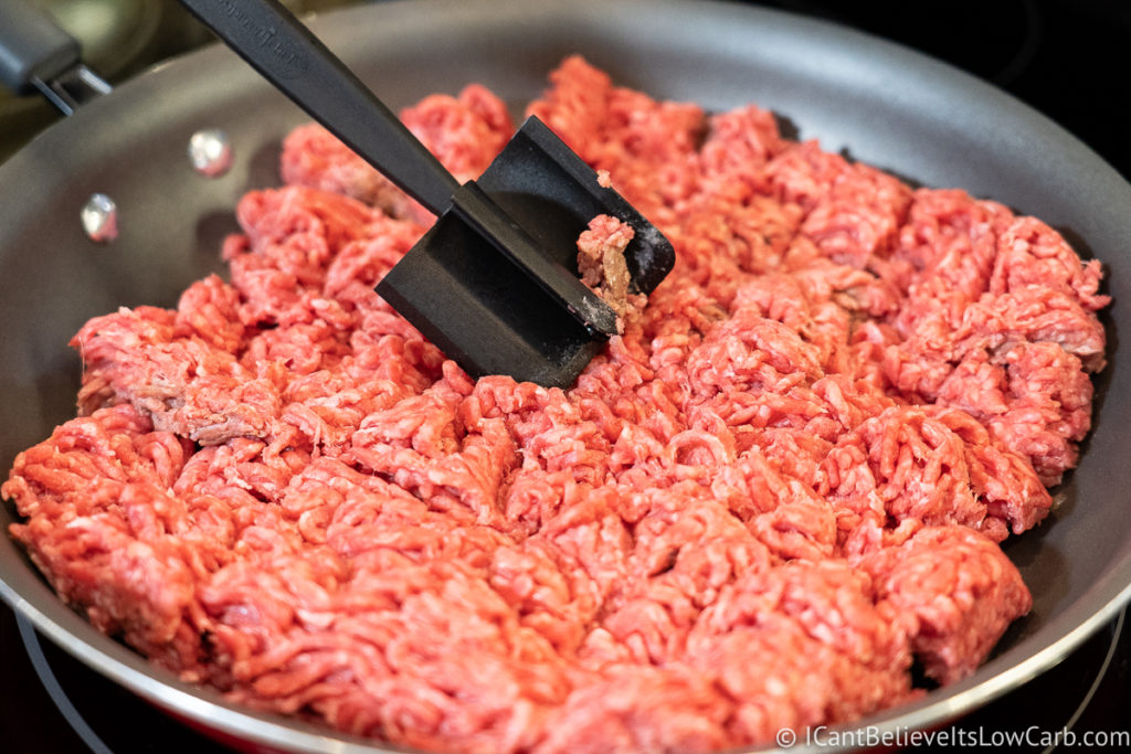 mixing up the meat in a pan