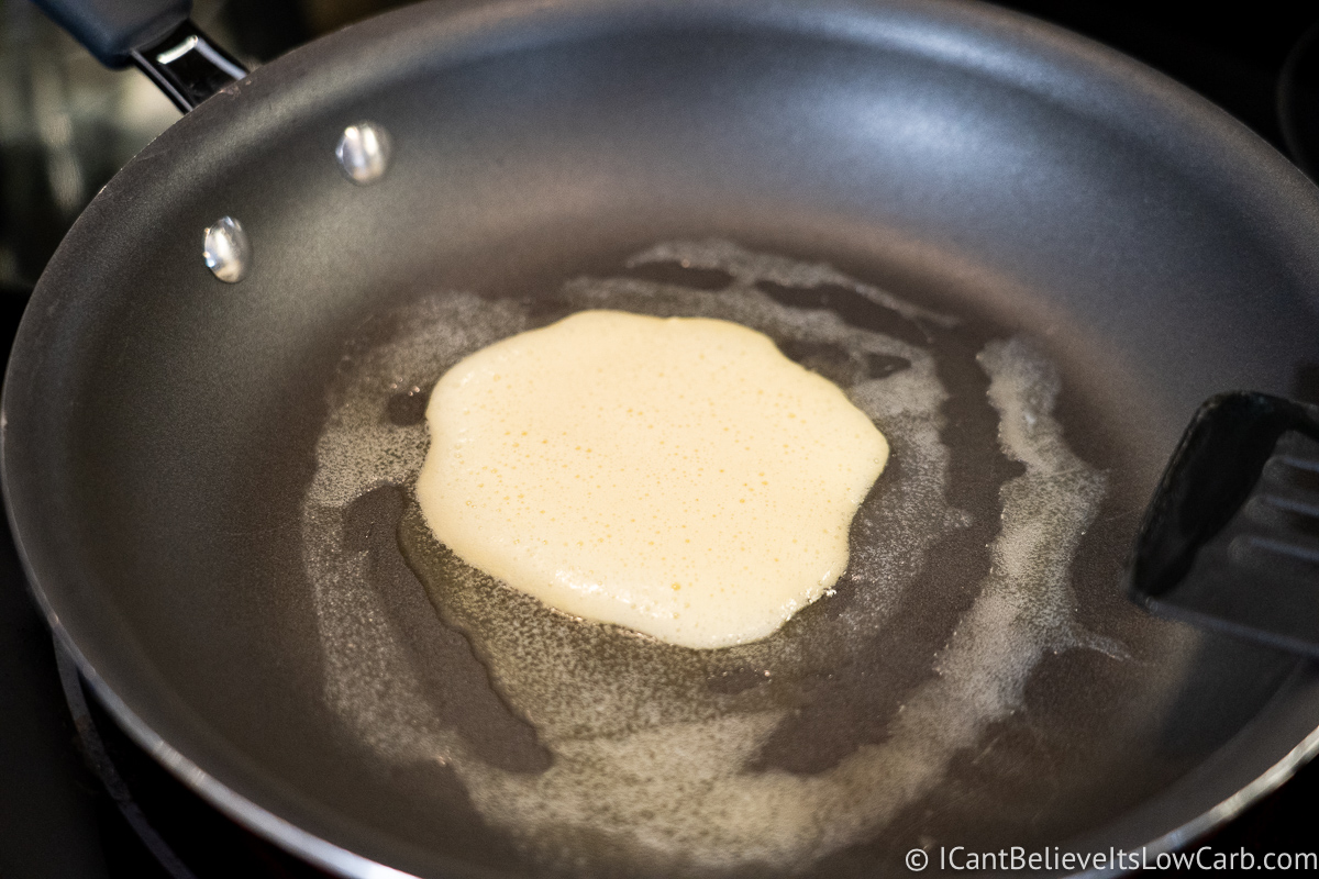 Cooking Keto Cream Cheese Pancakes in frying pan