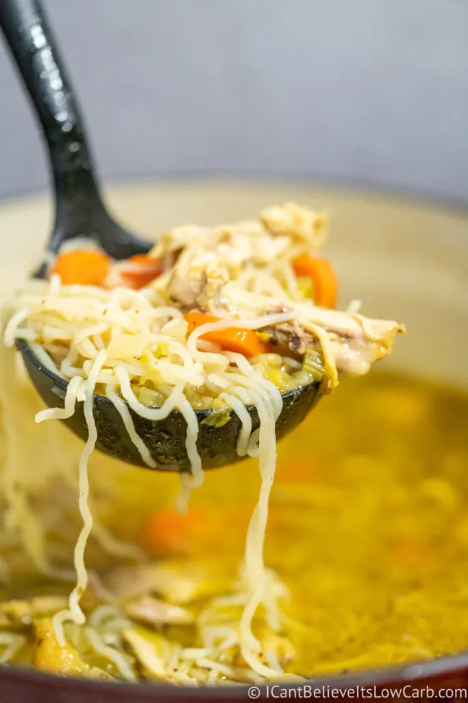 Picking up Keto Chicken Noodle Soup with a ladle